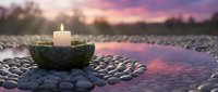 Peaceful zen meditation scene with burning candle in stone bowl surrounded by smooth pebbles at sunset reflecting in calm water for spa wellness relaxation.