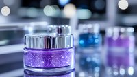 Luxurious purple glitter cosmetic cream jar with metallic silver cap on reflective surface against blurred bokeh background, elegant skincare product photography.
