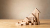 Wooden blocks arranged in ascending arrow formation showing business growth and success concept on natural wood surface.