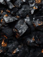 Dark volcanic rocks with glowing orange magma cracks create dramatic natural texture. Abstract geological background showing contrast between cold stone and hot lava.