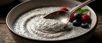 Chia seed pudding with fresh berries and spoon in bowl, ready-to-eat breakfast or dessert option.