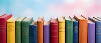 Row of colorful antique books with worn spines arranged side by side, perfect for library, education, literature, and reading-themed designs and publications.