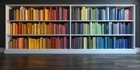 Colorful books arranged by spectrum colors on modern white bookshelf against dark wall, creating rainbow gradient effect on wooden floor. Interior design concept.