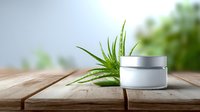 White cosmetic cream jar with fresh aloe vera leaves on wooden table against blurred green background, natural skincare and beauty product packaging mockup.