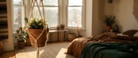 Cozy bedroom interior with hanging macramé plant holder, natural sunlight from windows, warm earth tones, and potted plants creating a relaxing bohemian home decor space.