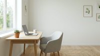 Modern minimalist home office workspace with wooden desk, gray chair, laptop and plant by window for remote work productivity and interior design.