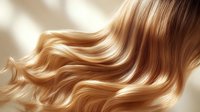 Luxurious golden blonde hair with smooth waves flowing gracefully against soft light, showcasing healthy shine and natural movement for beauty and haircare advertising.