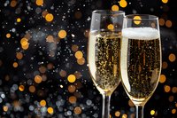 Sparkling champagne flutes with golden bubbles against dark background with glowing bokeh lights, celebrating special occasion or holiday season.