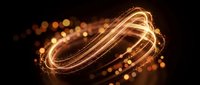 Golden light trails creating dynamic swirling motion with glowing particles and bokeh effects on dark background for modern digital design projects.