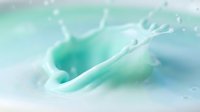 Liquid splash in turquoise and white tones creating dynamic motion and droplets, suitable for cosmetics, skincare, beverage, and wellness product marketing materials.