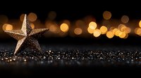 Golden starfish on dark glittering surface with magical bokeh lights in background creating dreamy holiday atmosphere for seasonal decorative designs.