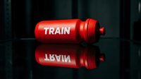 Red training water bottle with white text on dark reflective surface, ideal for fitness, gym, sports marketing, and wellness promotional materials.