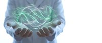Businessman holding glowing green energy waves in cupped hands representing renewable power, sustainability concepts, and environmental technology solutions.