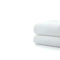 Stack of two folded white cotton towels on clean background for bathroom decor, spa treatments, hotel amenities and hygiene product advertising.
