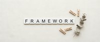 Wooden letter tiles spelling FRAMEWORK with eucalyptus branch and clothespins on neutral background for business planning concepts.