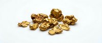 Golden metal nuggets scattered on white background isolated for mining industry and precious metals investment concepts.