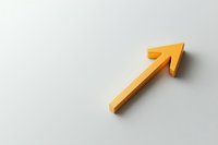 Yellow diagonal arrow pointing upward on white background with soft shadow, minimalist business concept representing growth and success.