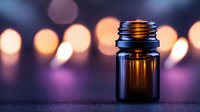 Amber glass essential oil bottle with warm bokeh lights creating atmospheric spa and aromatherapy mood for wellness and relaxation concepts.