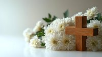 Wooden cross with white chrysanthemum flowers on light background, spiritual and religious composition for funeral, memorial service or Easter celebration.