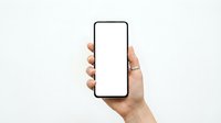 Female hand holding modern smartphone with blank white screen mockup against light background for app presentation and mobile interface design.