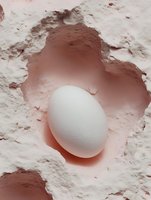 White egg nestled in pink clay powder creating heart-shaped impression, organic textures and soft pastel tones for culinary and wellness concepts.