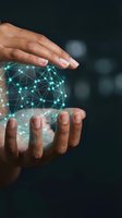 Hands protecting glowing digital network sphere with connected nodes and lines representing data protection, cybersecurity and technology innovation concepts.