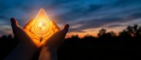 Silhouetted hands holding glowing shield symbol at sunset, representing security, protection, and trust for business, technology, and safety concepts.