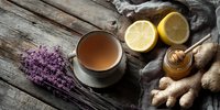 Soothing herbal tea with honey, lemon, ginger, and lavender on rustic wooden table. Natural remedy for cold and flu season.