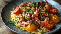 Grilled shrimp pasta with cherry tomatoes and fresh herbs in dark bowl, gourmet seafood dish ready for restaurant menu or cooking blog content.