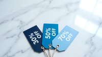 Three blue discount tags showing 30%, 50%, and 70% off on marble surface, perfect for retail sale promotions and shopping concepts.
