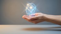 Human hand holding glowing geometric diamond shape with light rays, representing innovation, technology, and digital transformation for business and design projects.