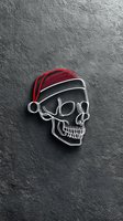 Skull wearing red Santa hat on dark textured concrete wall background for holiday horror themed designs and seasonal gothic decorations.