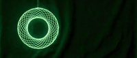 Glowing green neon wireframe torus spinning in dark space, modern digital art for technology, science fiction, and abstract design projects.