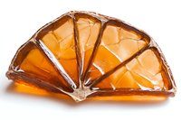 Orange citrus fruit slices made from amber glass with metallic edges arranged in fan shape on white background, decorative art piece for home decor and collecting.
