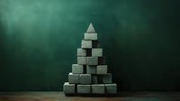 Minimalist pyramid structure made from rough concrete blocks stacked against dark green textured background, creating dramatic architectural composition.