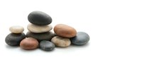 Smooth river stones and pebbles stacked in balanced arrangement on white background, isolated for wellness, spa, meditation and design projects.