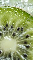 Fresh kiwi slice with water drops in macro view showing juicy pulp and black seeds, natural green fruit texture with sparkling droplets.