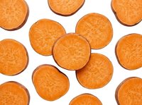 Fresh carrot slices isolated on white background showing natural orange color and circular cross-section pattern for healthy cooking and nutrition concepts.