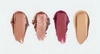 Four cosmetic smear swatches in nude, shimmer, berry, and beige tones isolated on white background for beauty and makeup design.
