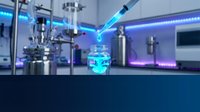 Laboratory pipette dispensing blue liquid into glass vial in modern research facility with advanced equipment and LED lighting for scientific experiments.