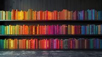 Colorful rainbow arrangement of books on dark wooden shelves creates striking visual display perfect for education, library, or knowledge concepts. Modern minimalist background design.