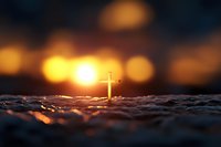 Golden cross silhouette on textured surface with warm bokeh lights creating spiritual atmosphere for religious and faith-based designs.