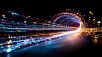 Glowing light trails forming luminous tunnel with blue and orange streaks against dark background, creating futuristic speed motion effect for technology concepts.