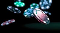Colorful casino chips floating in dark space with dramatic lighting effects and selective focus, creating dynamic gambling atmosphere on green background.