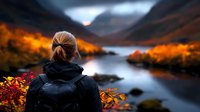 Blonde woman in black jacket contemplating scenic autumn lake view with red foliage, dramatic mountains and moody sunset sky reflecting in calm water.