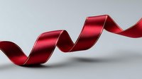 Elegant red satin ribbon curled in spiral shape floating on light gray background, isolated design element for festive decoration and gift wrapping.