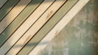 Weathered wooden planks with peeling paint in diagonal arrangement showing rustic texture and natural aging patterns for vintage design projects.