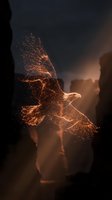 Majestic eagle soaring through dramatic sky made of glowing orange particles and sparks against dark stormy clouds for fantasy and freedom concepts.