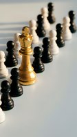 Golden chess king stands out among black and white pieces on board representing leadership, strategy, and business success in competitive environment.