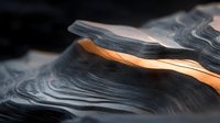 Abstract geological formation with smooth curved layers of dark gray and orange sandstone illuminated dramatically against black background.